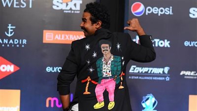 إسلام إبراهيم يرد على منتقدي إطلالاته بصورته مرسومة على ظهره